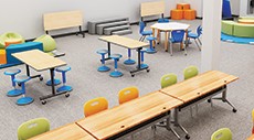 An overhead view of a modern classroom with tables, chairs, and portable soft seating.