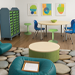 A rendering of a classroom space with soft seating, chairs, ottoman, table, stools and a nature-inspired rug. 