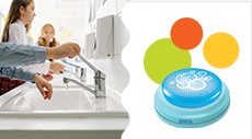 A young student washing their hands in a white sink on the left. On the right, a product (button) that helps young students with hand washing by keeping time.