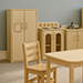 A student's playroom with wooden furniture. 